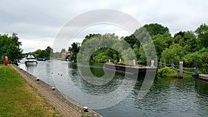 Boat approaching Bell Weir LockÂ is aÂ lockÂ on theÂ River ThamesÂ in England situated on the Surrey bank nearÂ Egham.